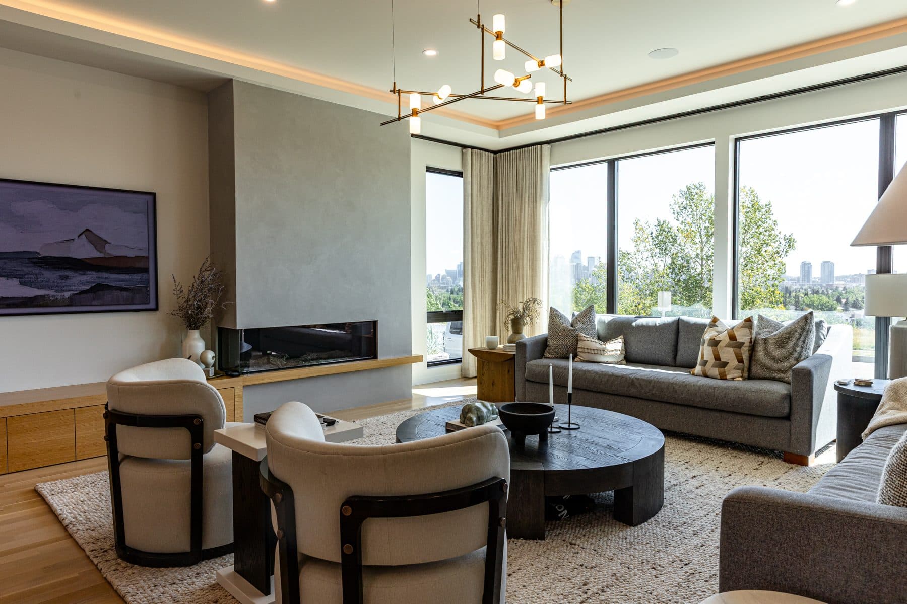 A living room fireplace set into a full-height stone surround, with plaster walls either side.