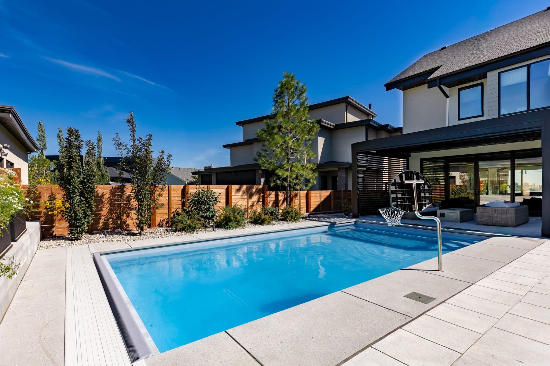 The rear elevation of a Riverside house, stepping down to the garden and pool terrace.