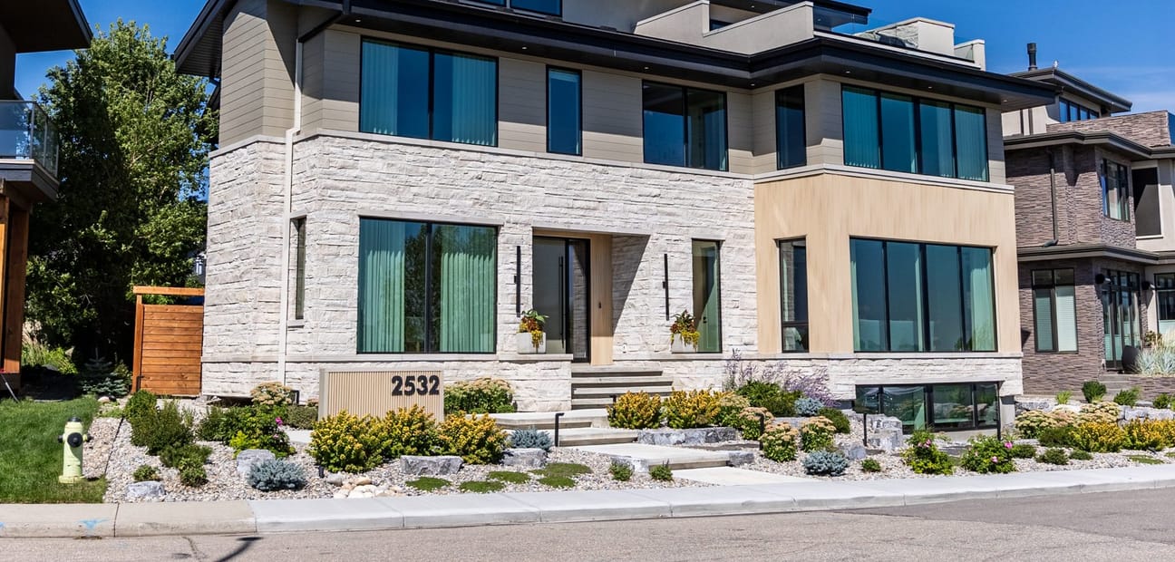 A recessed front entry with a full-height door, timber screen and stone threshold.