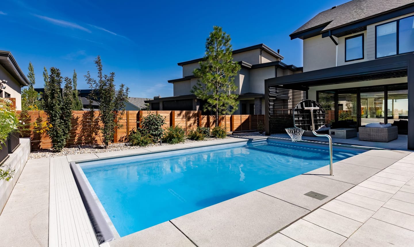 The rear elevation of a Riverside house, stepping down to the garden and pool terrace.
